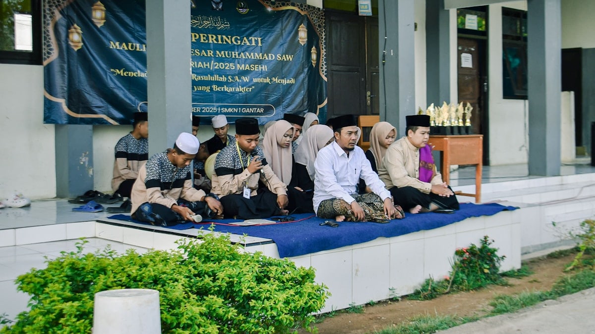 Group of young men sitting on mats outdoors